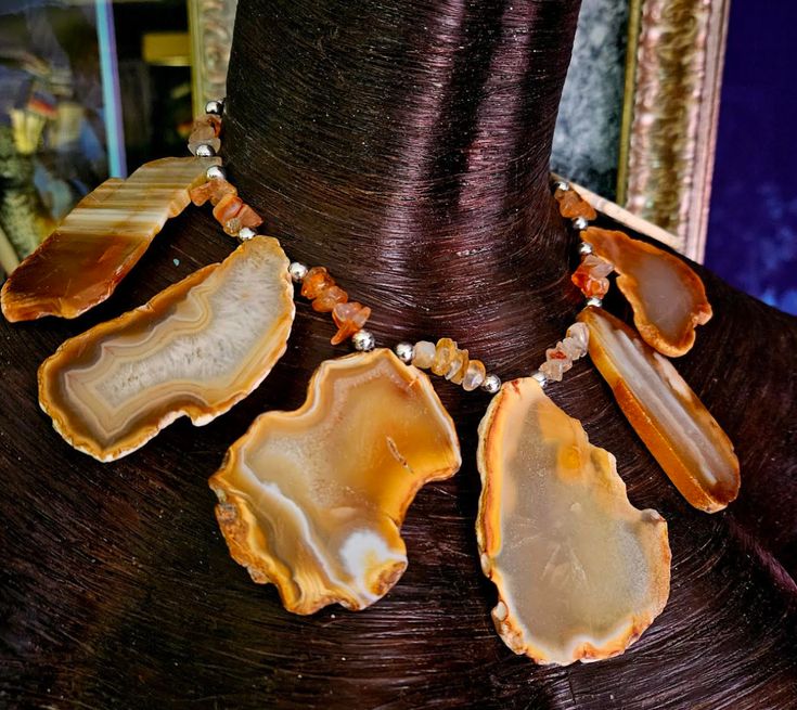 Here's a piece of my very early work that I had forgotten I even had. Seven earth tone agate slabs are displayed in a gemstone statement bib with smaller polished agate nuggets and shiny silver tone balls. This is very lightweight and adjusts from 16-18" and I can add more links if requested. Has a sterling silver hook and a 2" extender chain. A versatile unisex piece that works with casual to business attire. From the Atelier of Kat Kouture. Rocker Chic Accessories, Unique Pendant Necklace, Statement Collar Necklace, Bib Collar, Statement Bib Necklace, Chest Piece, Mermaid Necklace, Agate Slice, Statement Pendant