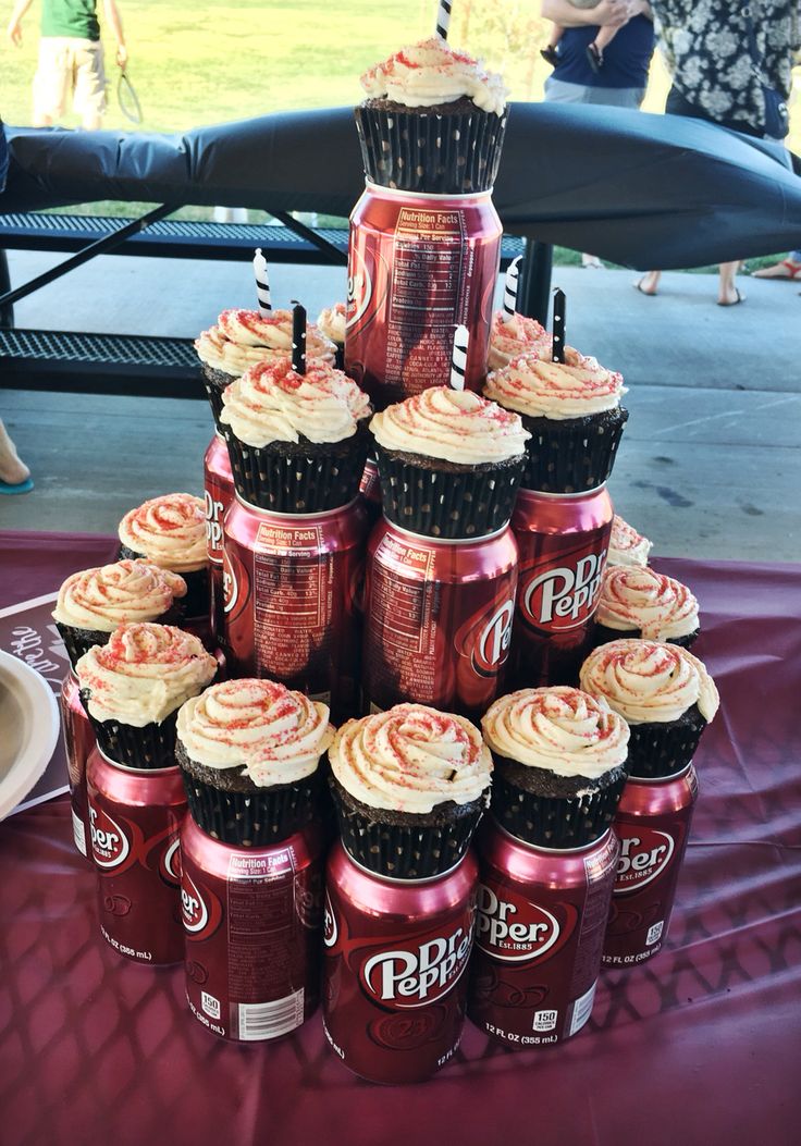 a large stack of cupcakes sitting on top of each other in front of a table