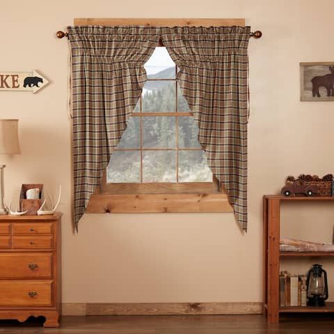 there is a window in the room with plaid curtains