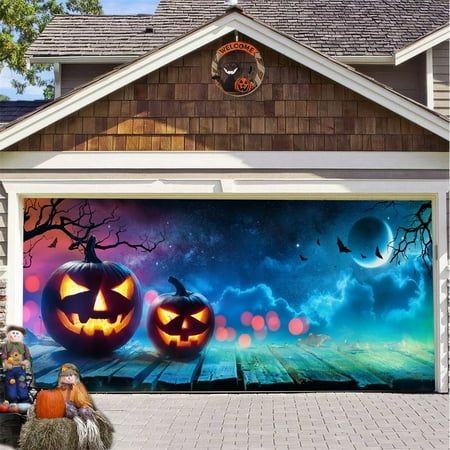 two pumpkins painted on the side of a garage door in front of a halloween scene