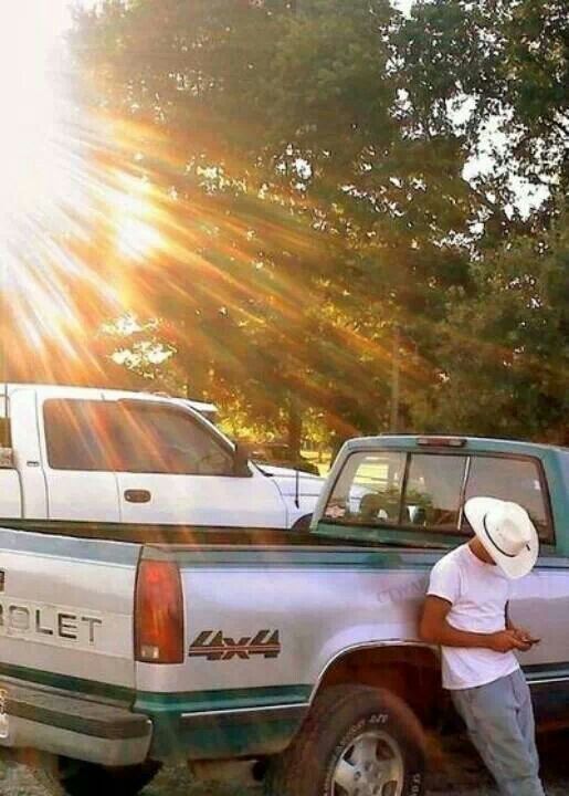 a man standing in the back of a pick up truck