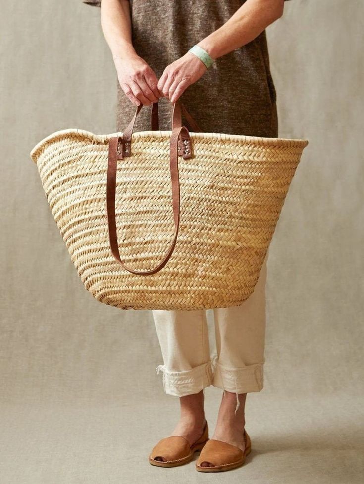 "Discover Genuine Moroccan Artistry in Our Handwoven Palm Leaf Bag Handmade in the Heart of Morocco, this exquisite bag embodies the essence of 'Slow Fashion,' embracing eco-consciousness and ethical values, even amidst the prevailing straw trend of this Spring & Summer. Meticulously handwoven by skilled Marrakech artisans, our wicker French basket is a versatile companion, perfect as a small shopper or a chic beach bag. It's also an ideal gift for girls, suitable for carrying school books and m French Market Bag, How To Have Style, French Basket, French Market Basket, Moroccan Basket, Grocery Market, Braided Bag, French Baskets, Natural Baskets