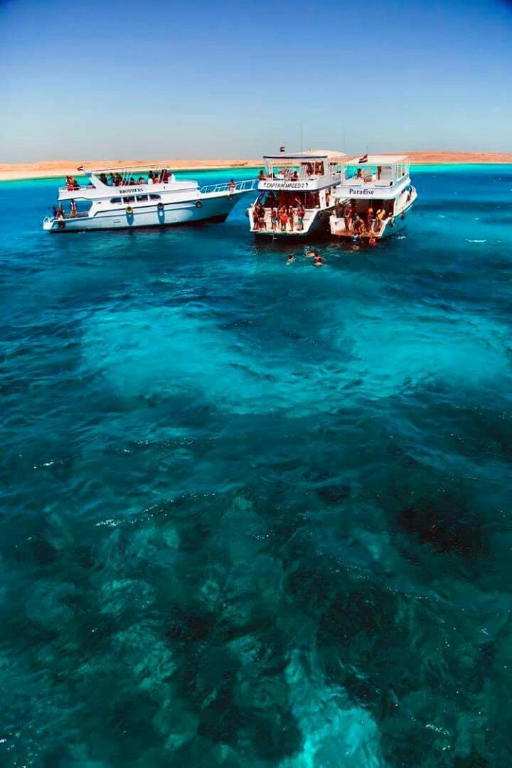 two boats in the water with people on them