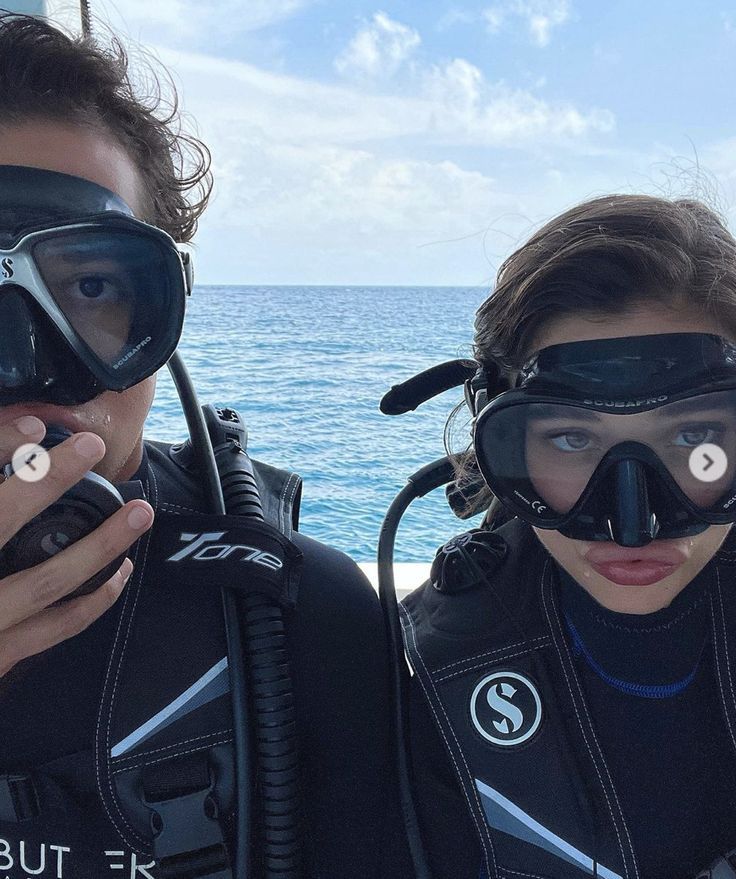 two people in scuba gear posing for the camera