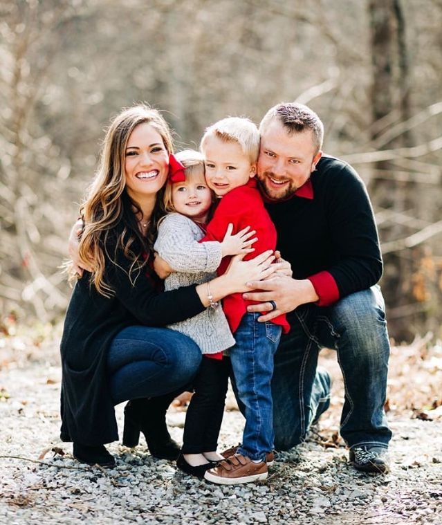 a family posing for a photo in the woods