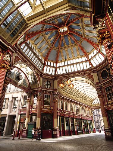 the inside of an old building with many windows and lights on it's ceiling