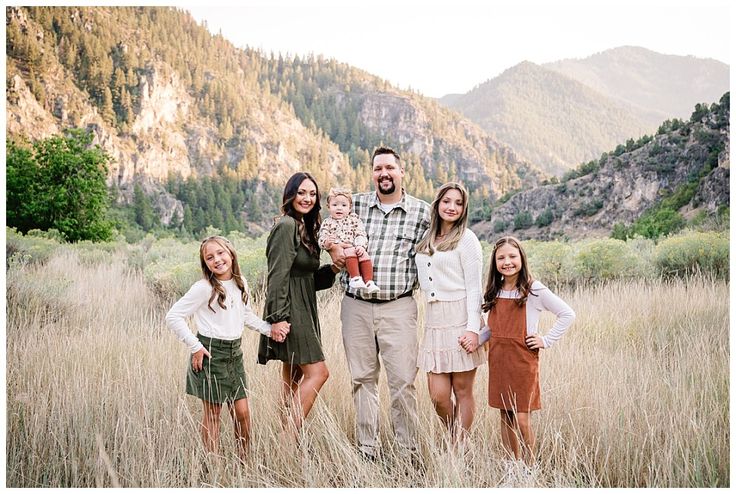 a family posing for a photo in the mountains