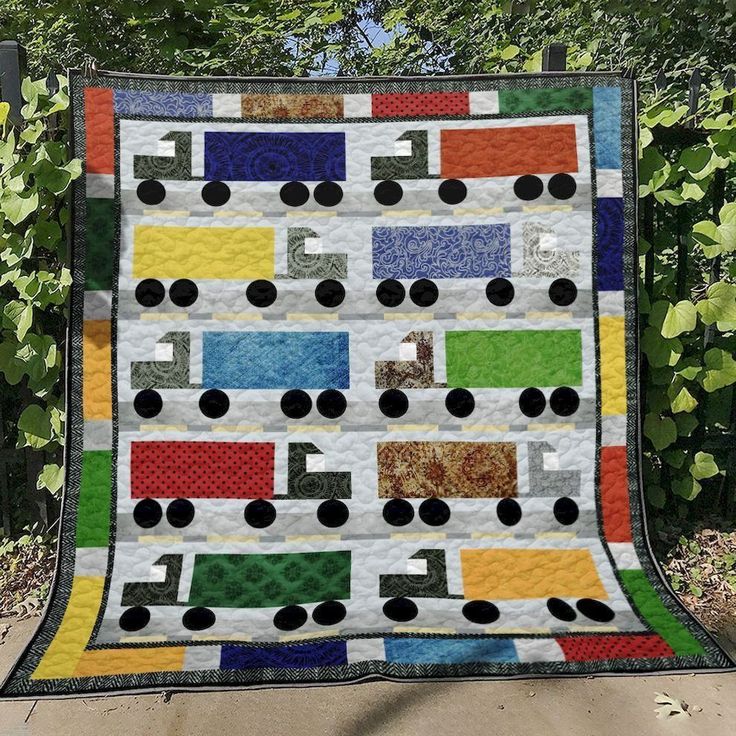 a quilt made to look like a train on the tracks, with black circles around it