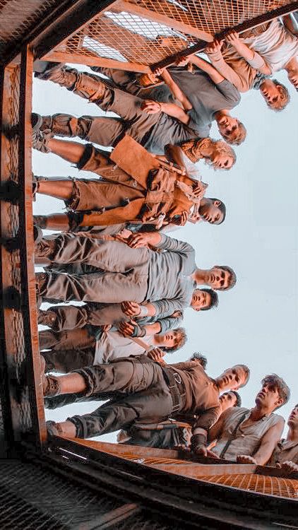 a group of people standing in front of a mirror