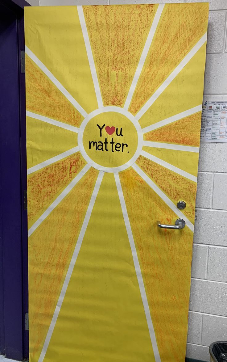 a yellow door with the words you matter written on it and a sunburst