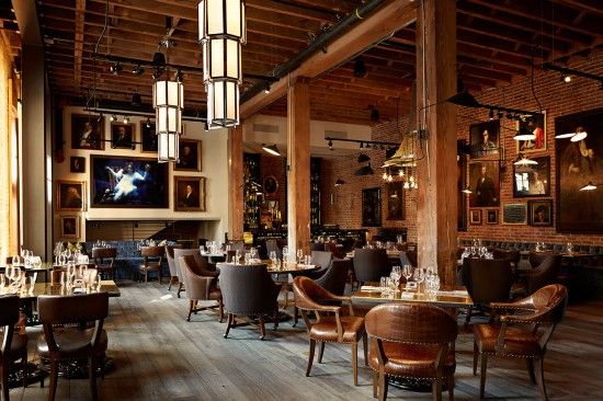 an empty restaurant with wooden floors and tables set up for people to sit at the table