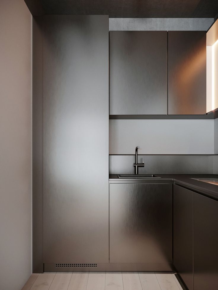 a modern kitchen with stainless steel cabinets and wood flooring