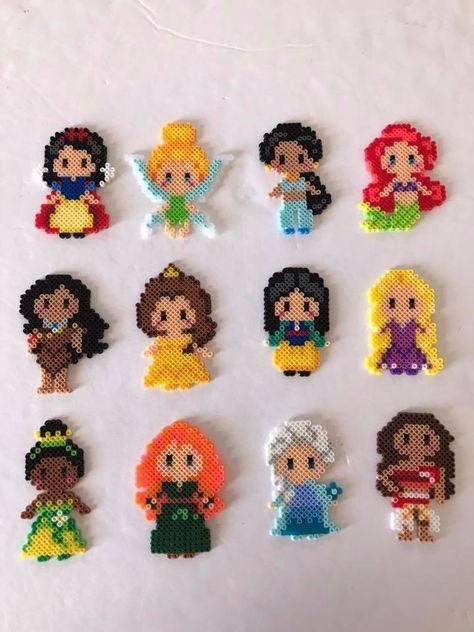 cross stitch disney princesses are displayed on a white surface