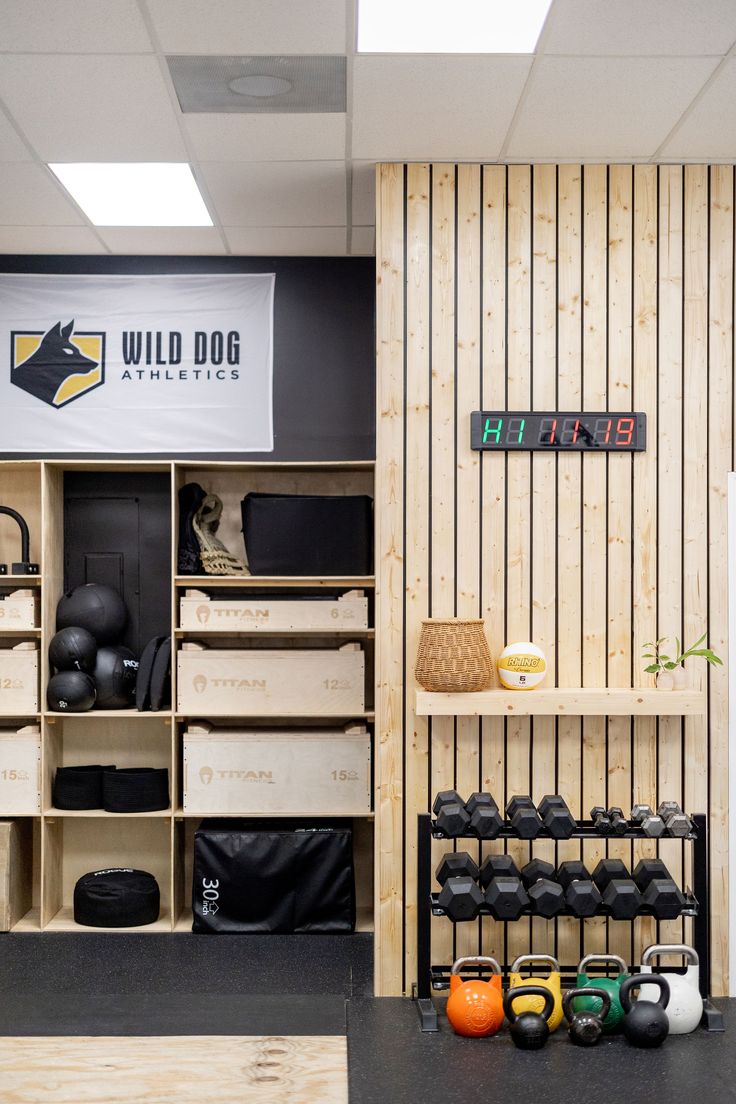 the inside of a gym with kettles and exercise equipment on display in front of a sign that reads wild dog athletics