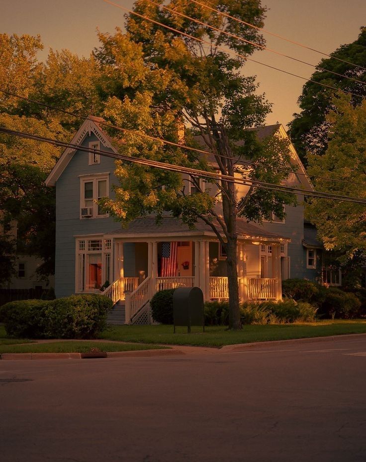 a blue house sitting on the side of a road