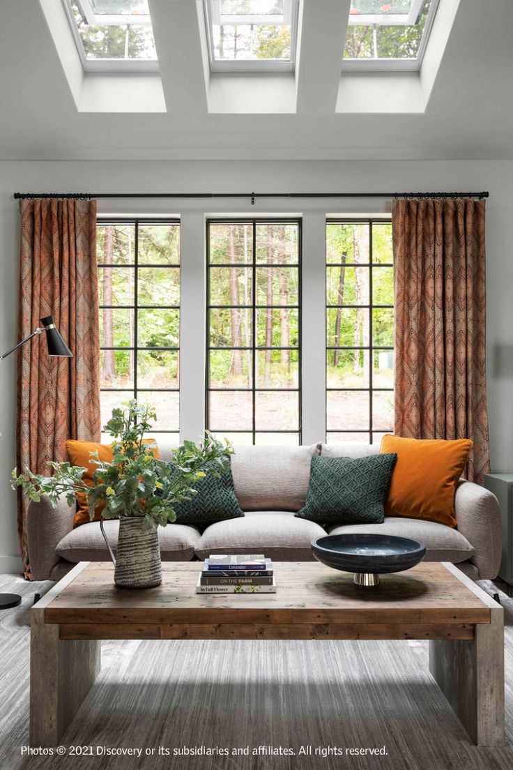 a living room filled with furniture and windows