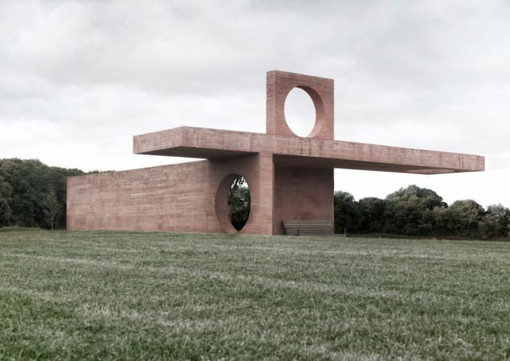 a large brick structure sitting on top of a lush green field