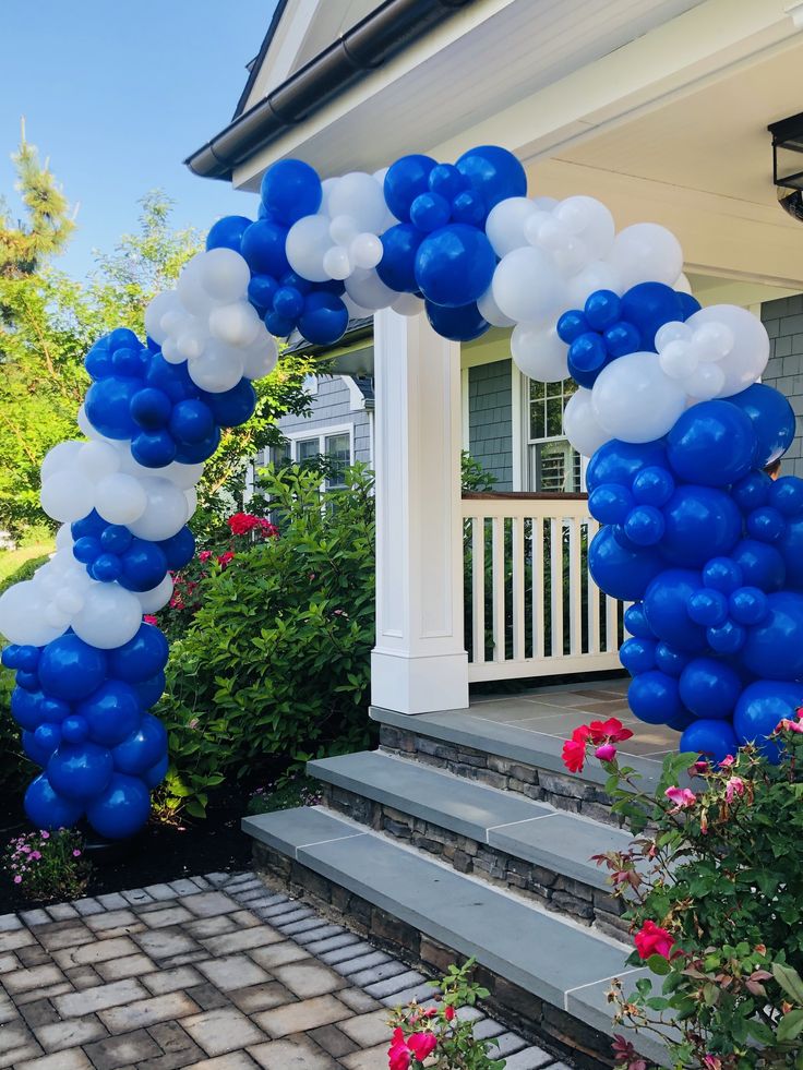 blue and white balloons are on the front steps