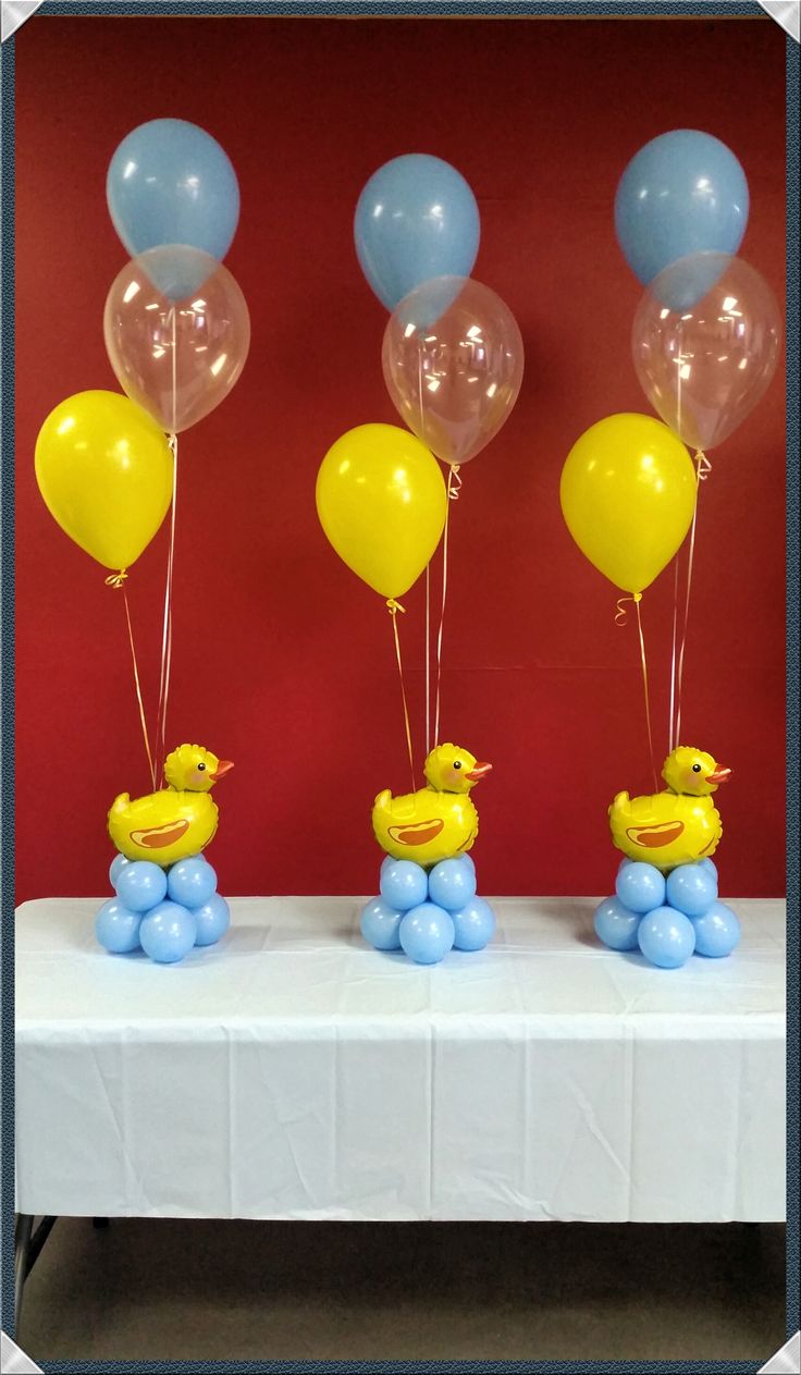 there are balloons and rubber ducks on the table