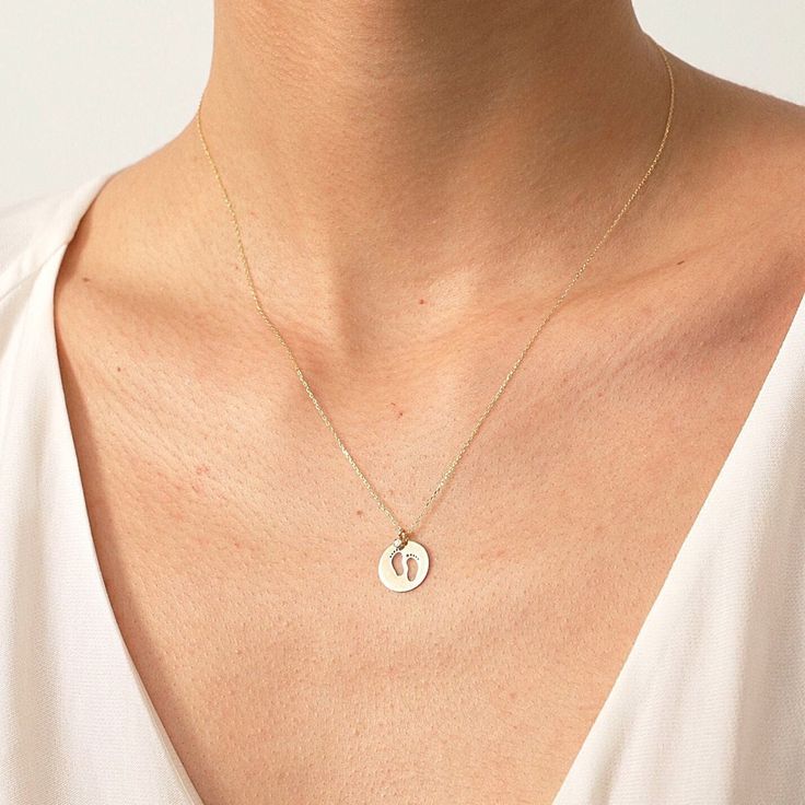 "Designed with a mother's warm touch in mind. Get her a 14k gold footprint memory to always remind her of the most beautiful moment in her life. The high-quality dainty diamond necklace that'll keep the memory of motherhood alive. The perfect gift for a perfect mom on Mother's day or a birthday. F E A T U R E S * Made to Order. * Gold KT: 14K * Choice of Gold Color: Yellow Gold, Rose Gold, White Gold * Gem Stone: Genuine Diamond * Diamond-Cut: Round * Diamond Carat: 0.01 ct * Pendant Height: 12 Yellow Gold Oval Jewelry For Birthday, 14k Gold Keepsake Necklace, 14k Gold Round Keepsake Necklace, 14k Gold Birth Flower Jewelry For Anniversary, 14k Gold Jewelry With Birth Flower For Anniversary, Dainty 14k Gold Keepsake Jewelry, Tarnish Resistant Yellow Gold Jewelry For Birthday, 14k Gold Engraved Jewelry For Birthday, 14k Gold Tarnish-resistant Jewelry For Birthday