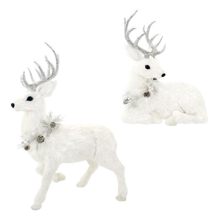 two white deer figurines sitting next to each other