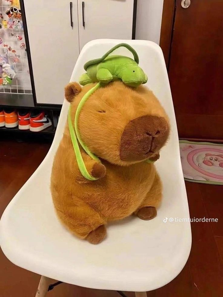 a stuffed animal sitting on top of a white chair