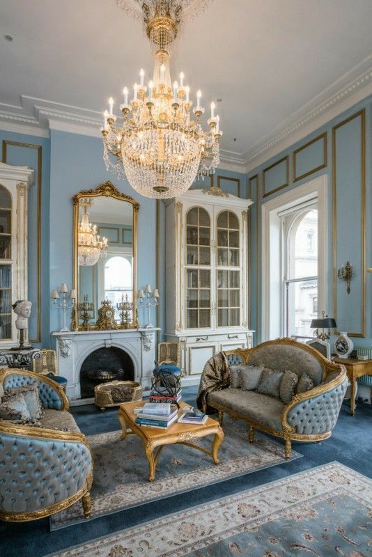 a living room filled with furniture and a chandelier