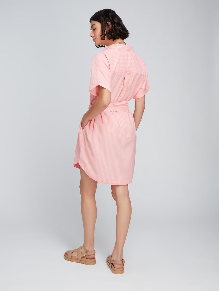 Is it a shirt or is it a dress? How about the best of both! The Diantha Shirt Dress has shape and silhouette of a shirt, but with the additional length of a dress. Great worn alone as a cover up on the beach, or with jeans or shorts – it's superbly versatile. Crafted with 100% BCI cotton, which means it's made with higher cotton farming standards, this pink stripe material is as ethical as it is pretty. Beach Summer Midi-length Shirt Dress, Beach Summer Midi Length Shirt Dress, Cotton Collared Shirt Dress With Tie Waist, Spring Day Out Dresses With Rolled Sleeves, Spring Dresses With Rolled Sleeves For Day Out, Feminine Cotton Shirt Dress For Day Out, Casual Midi-length Shirt Dress For Beach, Casual Midi Shirt Dress For Beach, Collared Cotton Shirt Dress With Tie Waist