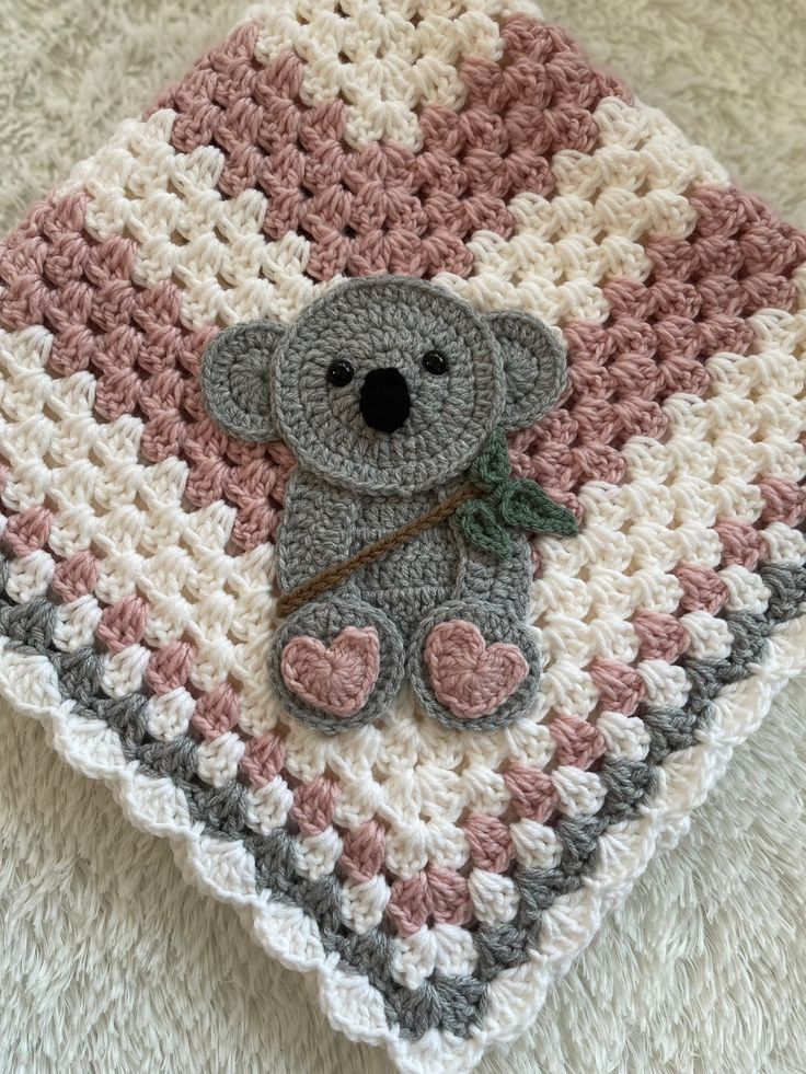 a crocheted blanket with a teddy bear on it