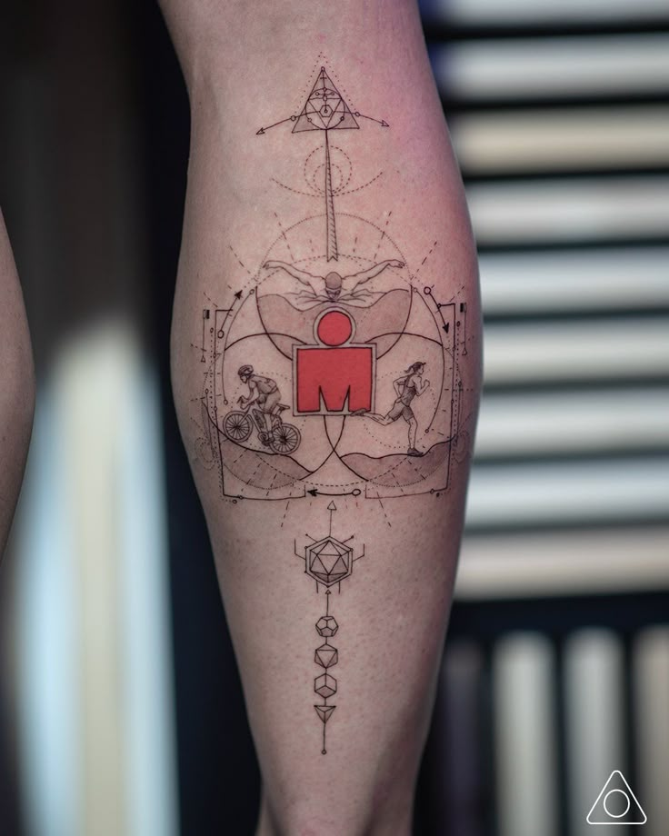 a woman's leg with a tattoo on it that has an image of the letter m