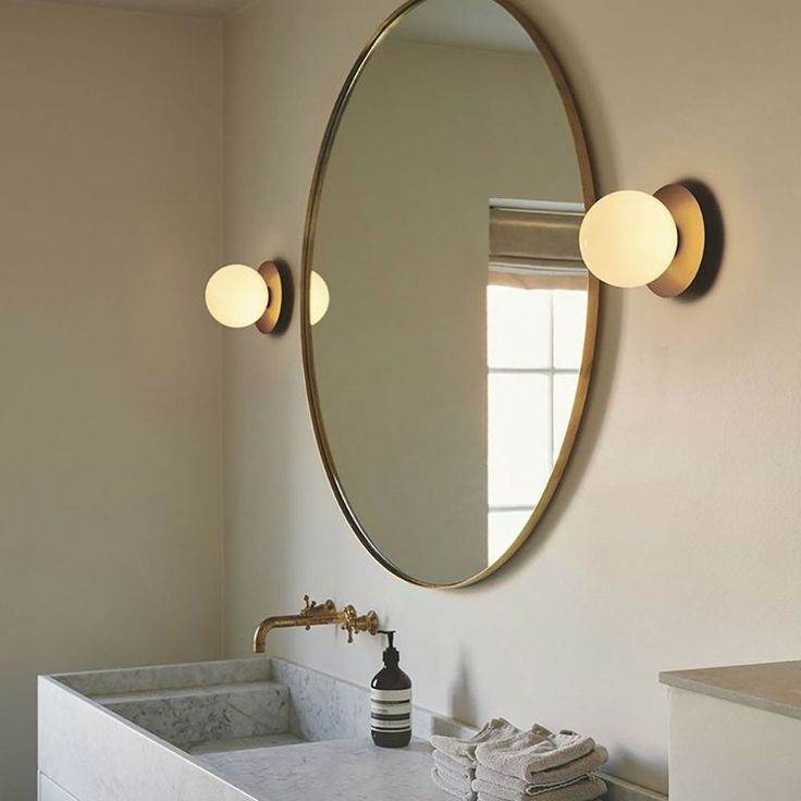 a bathroom sink sitting under a mirror next to a window