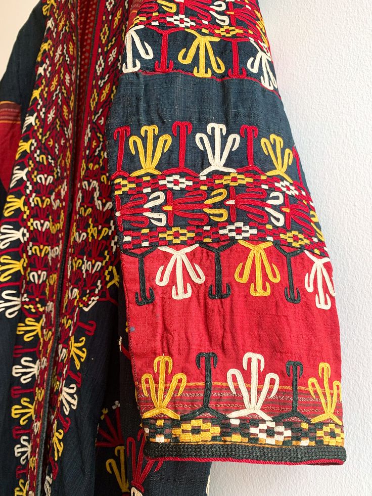 Fantastic traditional Turkmen robe/duster. Vivid colors and carefully embroidered workmanship. One of the best examples of this type of traditional wear we have come across. Infinitely wearable and looks great with jeans and boots. Add flair to a jeans and t uniform. Fabric: cotton/silk/ otherFit: S/MEra: 1940's Measurements: Bust 48" Sleeve (from collar) 32" Length 43" Waist 48" Hips 52" Condition: Excellent Traditional Cotton Tunic Kimono, Traditional Kaftan With Geometric Embroidery For Festivals, Traditional Multicolor Embroidered Geometric Kaftan, Folk Style Embroidered Multicolor Kimono, Folk Style Embroidered Ceremonial Kaftan, Traditional Multicolor Embroidered Kimono For Fall, Traditional Cotton Kimono With Multicolor Embroidery, Traditional Embroidered Fall Kaftan, Traditional Embroidered Kimono For Fall