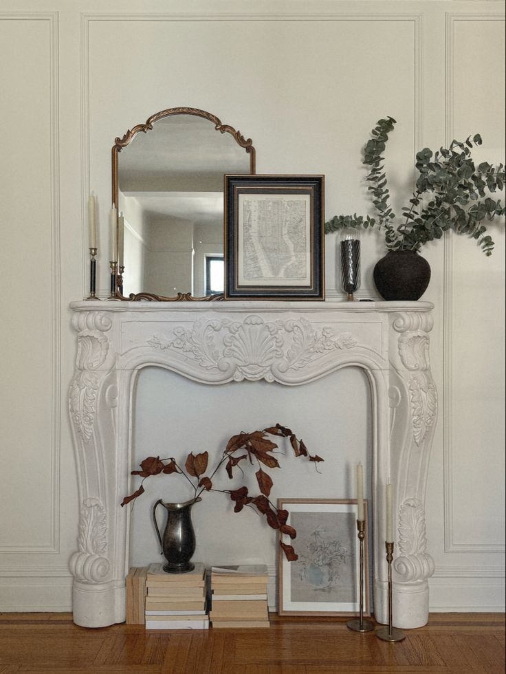 Elegant living room design showcasing a faux fireplace with a classic mantel, adorned with candles and decorative accents, embodying Parisian chic style. Layered Textiles, Mantel Styling, Antique Mantel, Parisian Decor, Curated Decor, Faux Fireplace, Decor Elements, Cast Stone, Dream Apartment