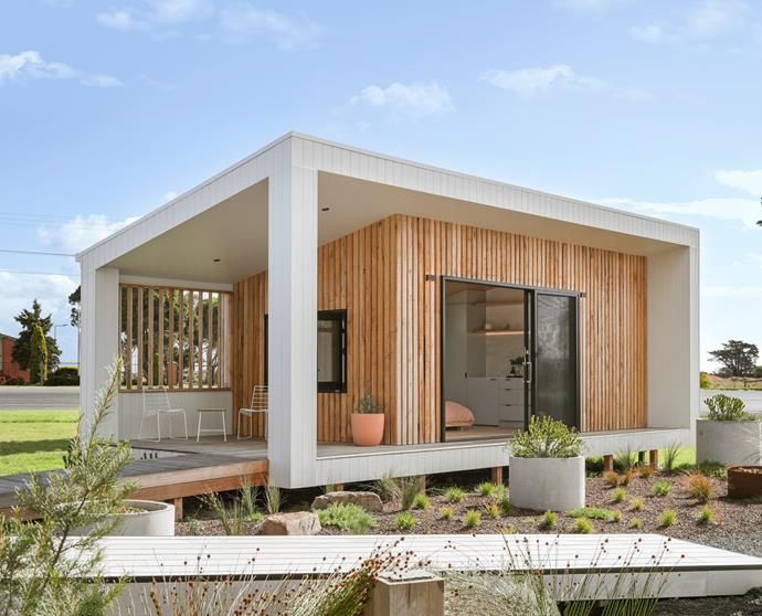 a modern house with wooden siding and white walls