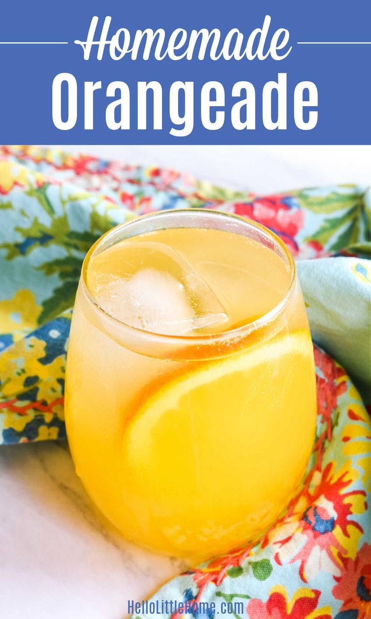 a glass filled with lemonade sitting on top of a table