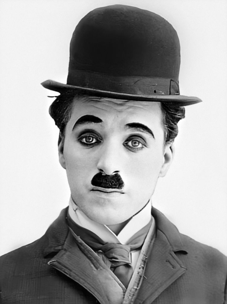 a man wearing a top hat and suit with a moustache on his face