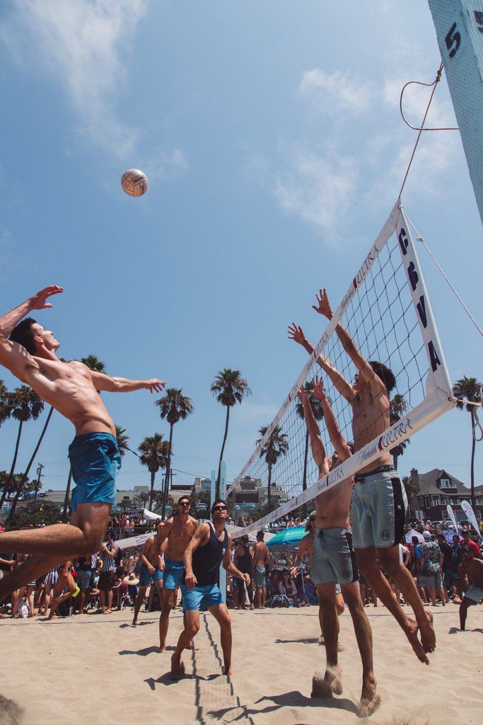 people are playing volleyball on the beach