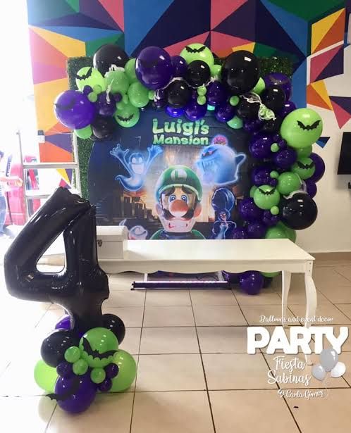 the balloon arch is decorated with black, green and purple balloons that spell out'4 '