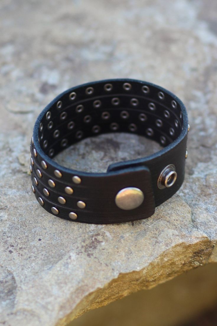 This studded cuff gives the illusion you are wearing four studded bracelets! -Color: Black -Handmade -Genuine leather -Measurements: 9"L -Imported Adjustable Punk Cuff Bracelet With Rivets, Punk Adjustable Cuff Bracelet With Rivets, Punk Style Adjustable Cuff Bracelet With Rivets, Punk Cuff Bracelets With Rivets, Edgy Adjustable Cuff Leather Bracelet, Punk Black Bracelet With Silver Studs, Edgy Bracelets With Rivets For Festival, Adjustable Rivet Bracelets For Festivals, Adjustable Black Wristband With Rivets