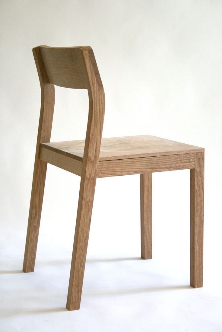 a wooden chair sitting on top of a white floor