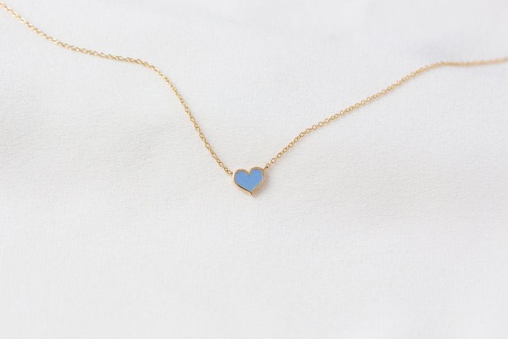 "*This listing is for one mini pastel blue enamel heart necklace, in solid 14K gold of your choice and choice of chain length. (pictured in solid 14K yellow gold) Meet our cutest and most cheerful enamel heart necklace with a pop of colour. Each necklace features a petite heart with meticulously hand applied enamel in solid 14K gold of your choice. This dainty necklace wears well on its own, and are also perfect for layering with any of our pieces. Specifications: - Solid 14K gold of your choice Blue 14k Gold Heart Pendant Jewelry, Tiny Blue Jewelry For Anniversary, Dainty Blue Charm Necklace For Everyday, Blue Dainty Jewelry For Valentine's Day, Simple Blue Everyday Jewelry, Blue Minimalist Personalized Jewelry, Personalized Blue Minimalist Jewelry, Blue Heart-shaped Jewelry With Adjustable Chain, Blue Heart Necklace With Adjustable Chain