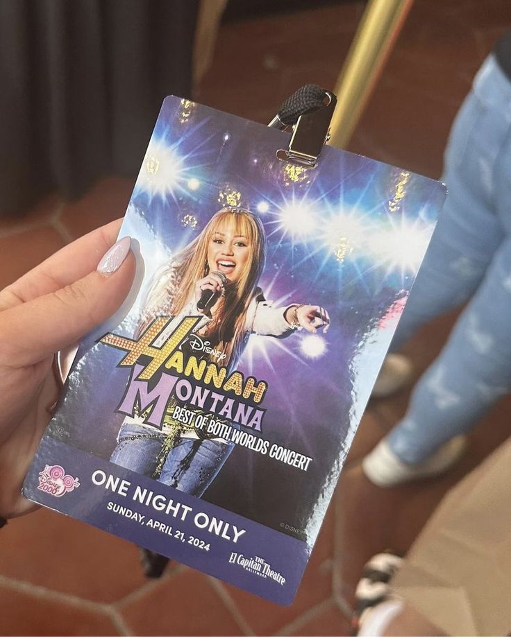 a person holding up a concert ticket for hannah montana on the show one night only