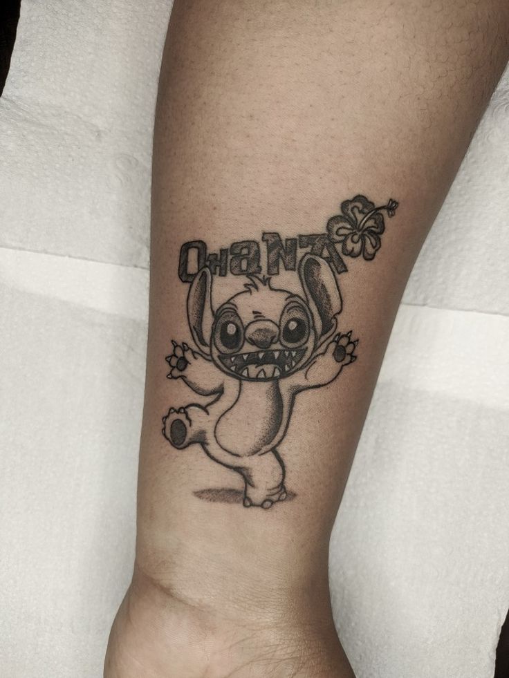 a person with a small tattoo on their arm that says ohana and an elephant