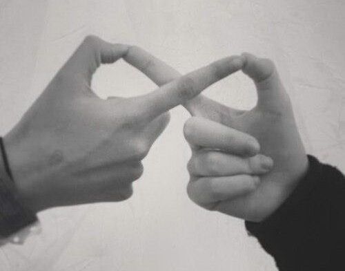 two hands making a heart shape with their fingers