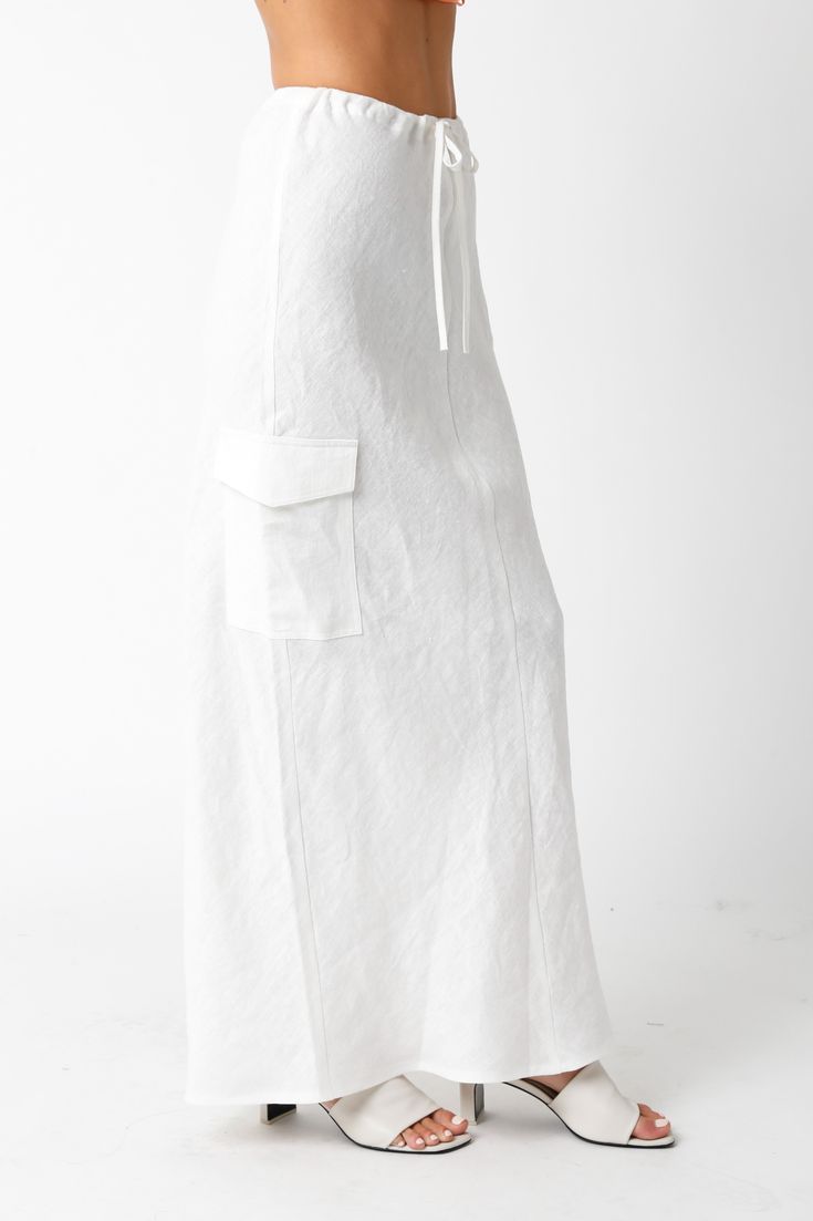 The Kaia White Linen Cargo Maxi Skirt is the perfect vacation cover-up! White linen woven fabric shapes this cargo maxi skirt with a mid-rise fit and drawstring tie. Style with sandals and a cute top and wear to dinner! DETAILS & FIT Loose Fit. 100% Linen. Machine wash cold. Imported. Beachwear Maxi Skirt For Day Out, Relaxed Cargo Skirt With Elastic Waistband For Summer, Summer Cargo Skirt With Elastic Waistband And Relaxed Fit, Summer Cargo Skirt With Elastic Waistband, Spring Beach Maxi Skirt With Tie Waist, Summer Tiered Maxi Skirt With Pockets, Chic Summer Midi Cargo Skirt, Casual Beach Skirt With Drawstring, Tiered Maxi Skirt With Pockets For Day Out