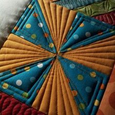 a close up view of a quilted piece of cloth with circles and dots on it