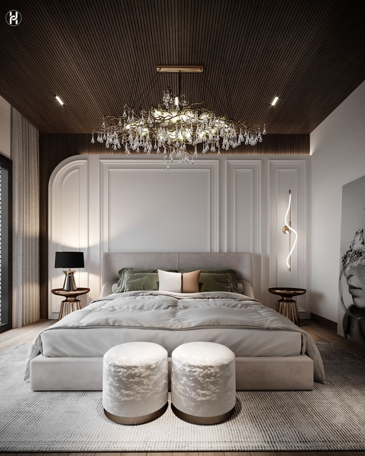 a large white bed sitting under a chandelier