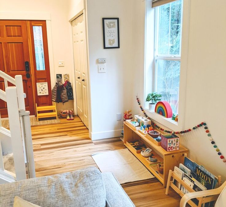 a living room filled with furniture next to a wooden door and window covered in christmas decorations