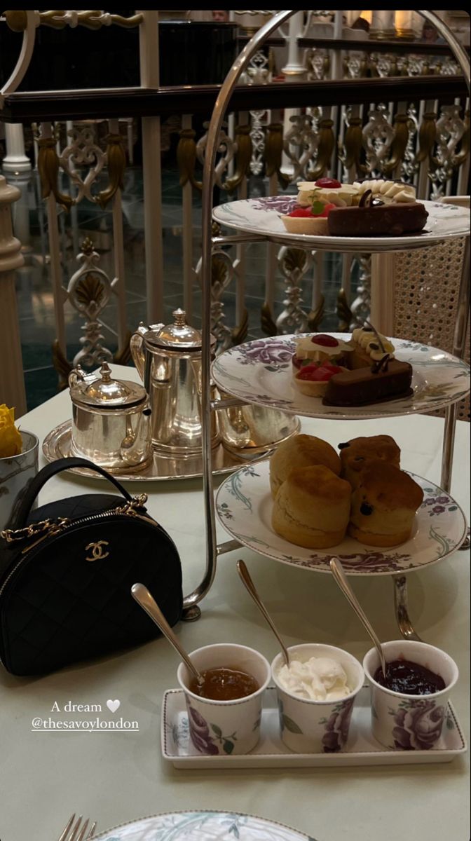 three tiered trays filled with pastries on top of a table