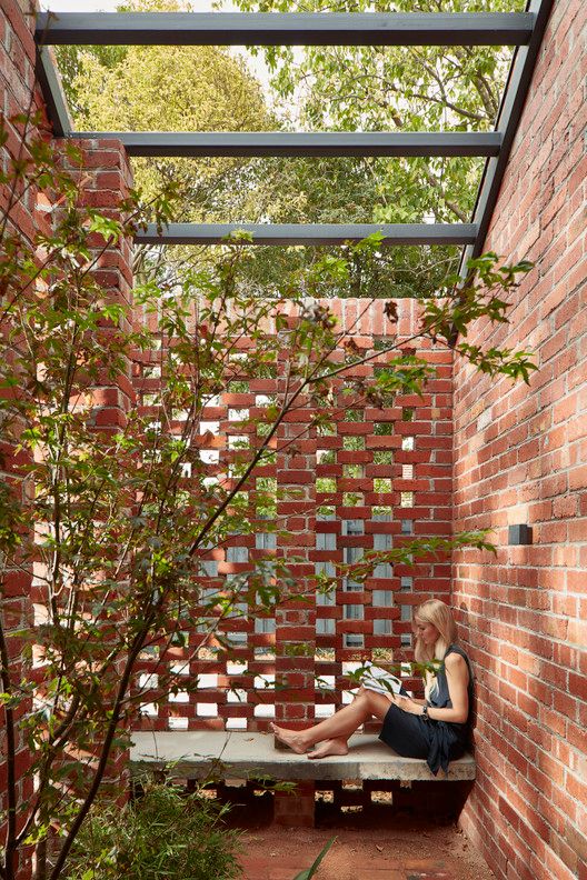 a woman sitting on a bench reading a book